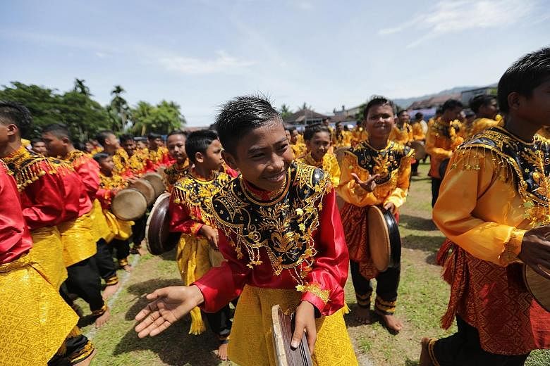 More than 2,000 boys dressed in colourful traditional costumes took part yesterday in a mass dance in Aceh's capital city, Banda Aceh, to mark Indonesia's Independence Day. The 2,019 teenagers, one for each year, lined up playing the tambourine-like 