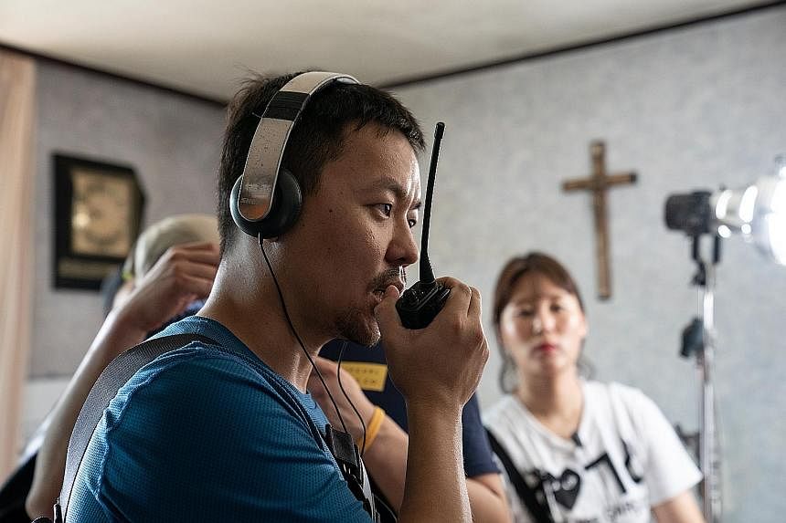 Directed by Kim Joo-hwan (left), The Divine Fury stars Ahn Sung-ki as a Catholic priest who performs exorcisms aided by a professional fighter played by Park Seo-joon (both above).