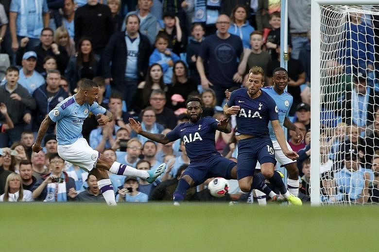 Left: Manchester City's Gabriel Jesus appeared to have scored the winning goal in time added on against Tottenham on Saturday but VAR disallowed the goal for a handball by Aymeric Laporte in the build-up. Below: Pep Guardiola having an exchange of wo