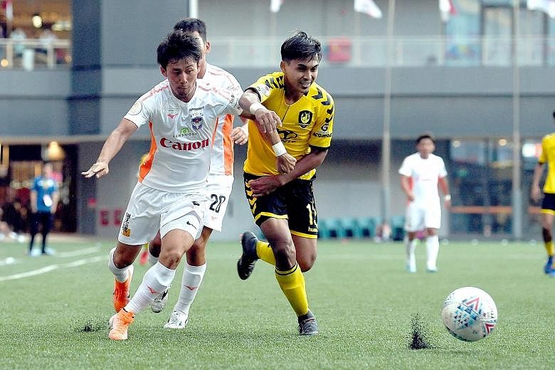Tampines' Taufik Suparno and Hiroyoshi Kamata chasing the ball during their Singapore Premier League match at Our Tampines Hub yesterday. Tampines won 2-0 to consolidate third place, two points behind joint leaders Brunei DPMM and Hougang United. ST 