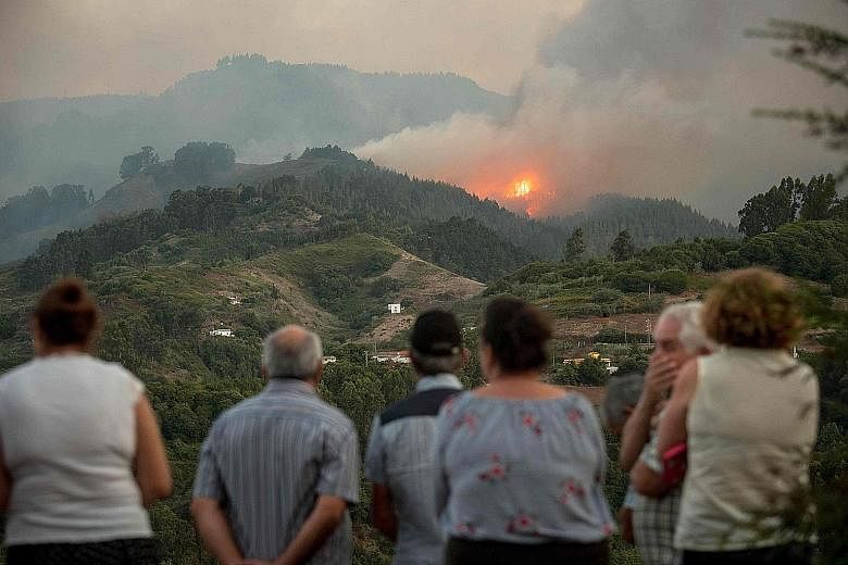 Residents watching smoke billowing from a forest fire raging near Montana Alta on the island of Gran Canaria, Spain, on Sunday.