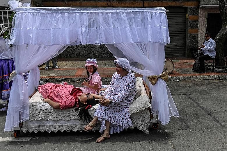 Women relaxing on a bed as a man played music nearby to celebrate the World Day of Laziness in Itagui, near Medellin, Colombia, on Sunday. The celebration was created in 1985, in the bustling industrial town of Itagui, to encourage stressed workers t