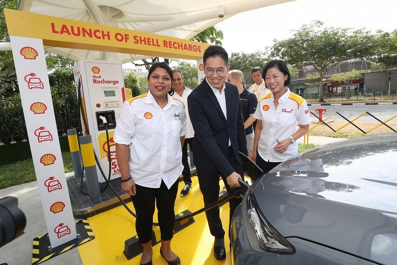 Shell's retail general manager Aarti Nagarajan, Economic Development Board managing director Chng Kai Fong and Ms Aw Kah Peng, chairman of Shell companies in Singapore, launching Shell's first electric vehicle charger in Singapore yesterday at the Du