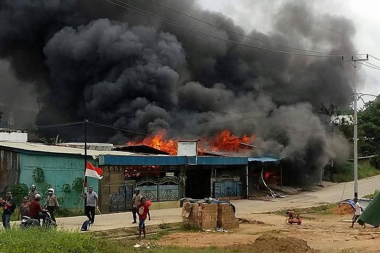 Rioting demonstrators also set fire to other buildings in Sorong city, in West Papua, yesterday. PHOTO: AGENCE FRANCE-PRESSE