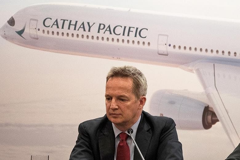 The resignation of Cathay Pacific CEO Rupert Hogg, seen here at a news conference in March, was first announced by China's state-run media last Friday. It came after the Chinese government accused the airline of endangering flight safety when some of