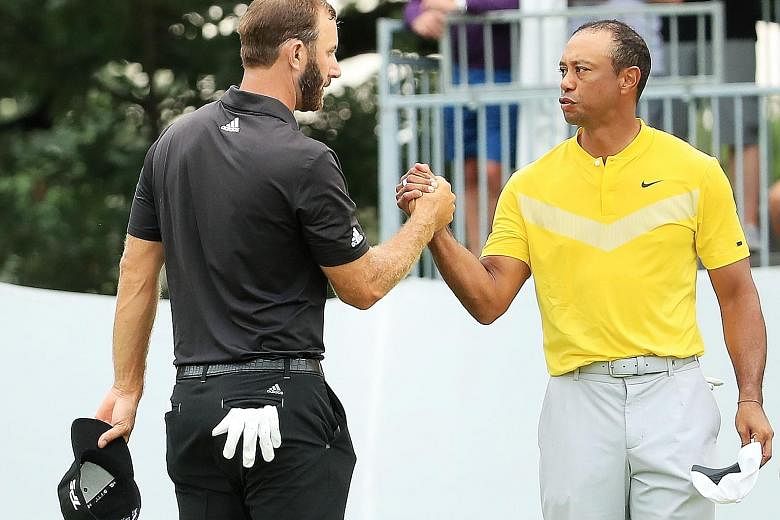 Tiger Woods (right) greeting fellow American Dustin Johnson at the BMW Championship last week. Both will be at the Presidents Cup in December, when Woods will skipper the US team.