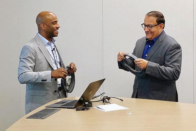 Microsoft principal technical architect Justin Preston giving Mr S. Iswaran a demonstration on the company's HoloLens, which will allow multiple industries to better leverage mixed-reality applications.