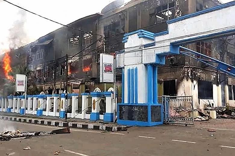 A burnt-out building in Sorong, West Papua, yesterday after it was set on fire by rioting demonstrators. The protests in West Papua were triggered by reports that the authorities had tear-gassed and detained 43 Papuan university students in Surabaya,