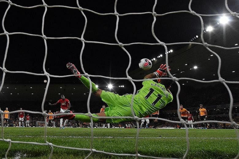 Wolves goalkeeper Rui Patricio going the right way to save Paul Pogba's attempt from the spot, preserving his side's parity with Manchester United during their 1-1 draw. It was Wolves' second draw this season.