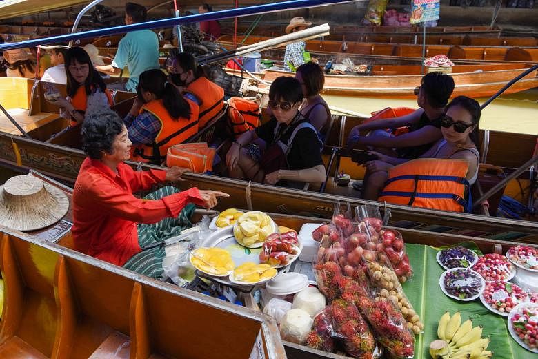 Tourists at the Damnoen Saduak floating market near Bangkok. Most travellers to Thailand are from China and other countries in the region, but millions also come from Europe and the United States, and currency conversion rates impact their decisions 