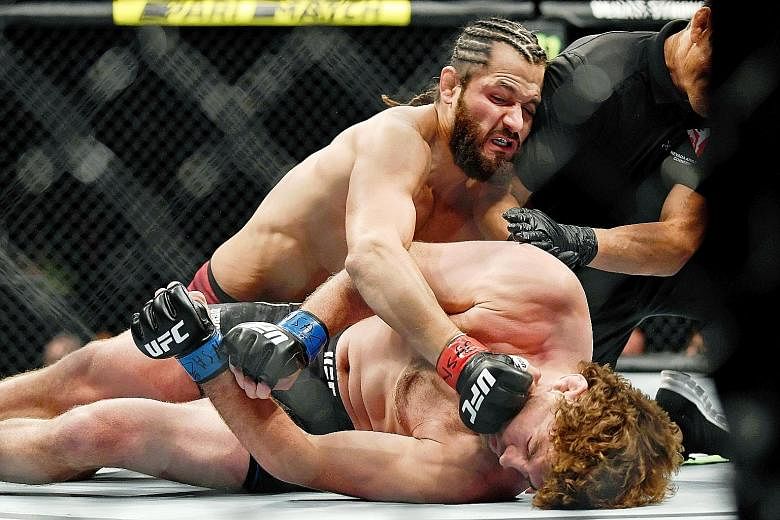 Jorge Masvidal landing punches on Ben Askren, forcing referee Jason Herzog to stop the July 7 fight in Las Vegas. The five seconds Masvidal took set a new record for the fastest knockout in UFC history. PHOTO: REUTERS