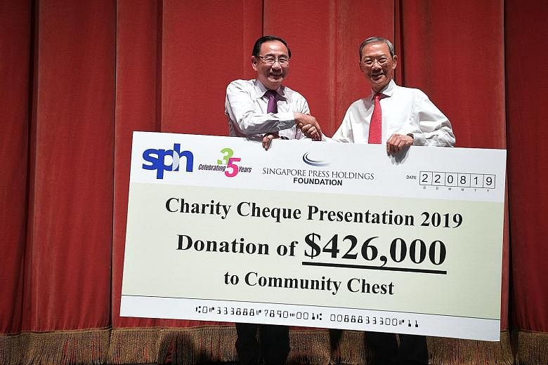 Dr Lee Boon Yang (right), Singapore Press Holdings and SPH Foundation chairman, presenting a cheque to Community Chest chairman Phillip Tan. The money will go to the Special Education Financial Assistance scheme and 20 charities. The anniversary conc