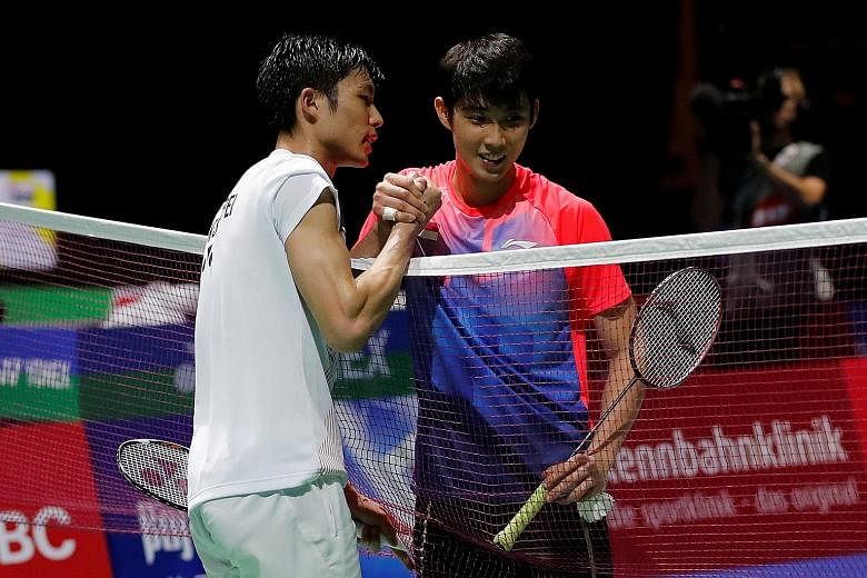 Chinese Taipei's Chou Tien-chen consoling Loh Kean Yew (right) at the net after beating the Singaporean in the third round of the BWF World Championships in Basel yesterday. While he exited the tournament, Yeo Jia Min (above) will play Thailand's Rat