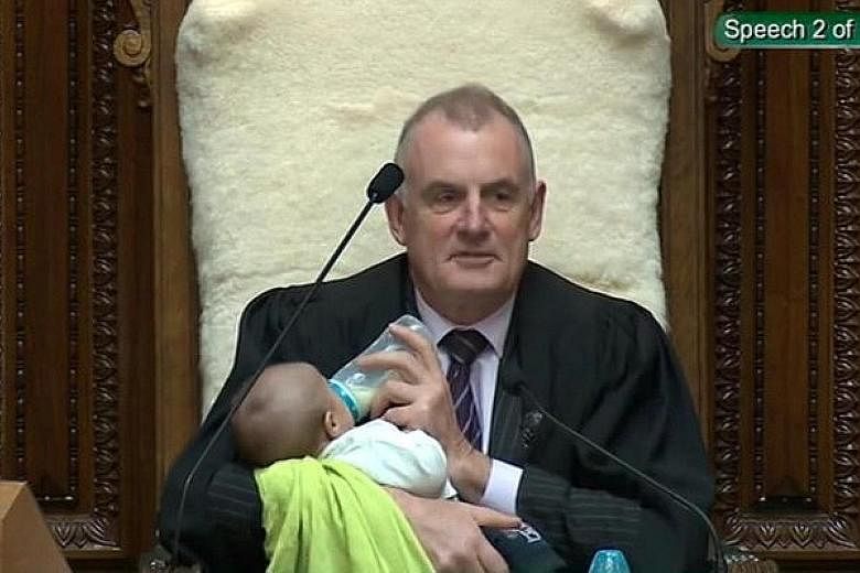 New Zealand Speaker Trevor Mallard feeding an MP's baby during a parliamentary session in Wellington on Wednesday. PHOTO: REUTERS