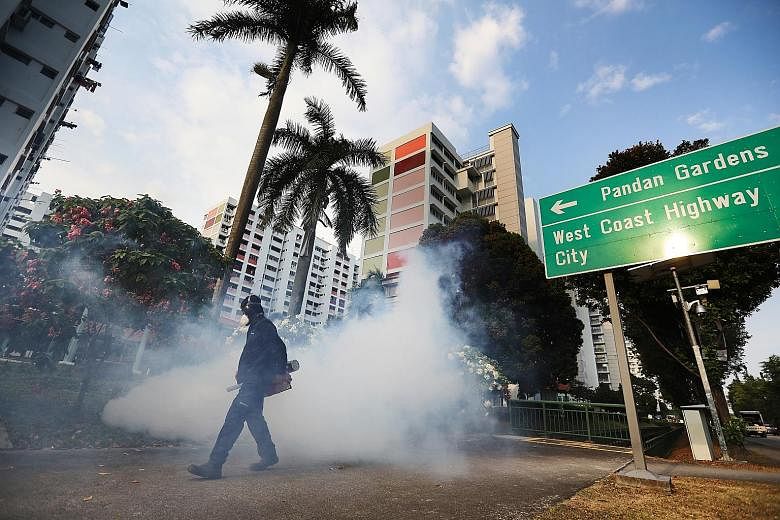A PUB contractor carrying out fogging at Housing Board blocks near Pandan Reservoir earlier this month.