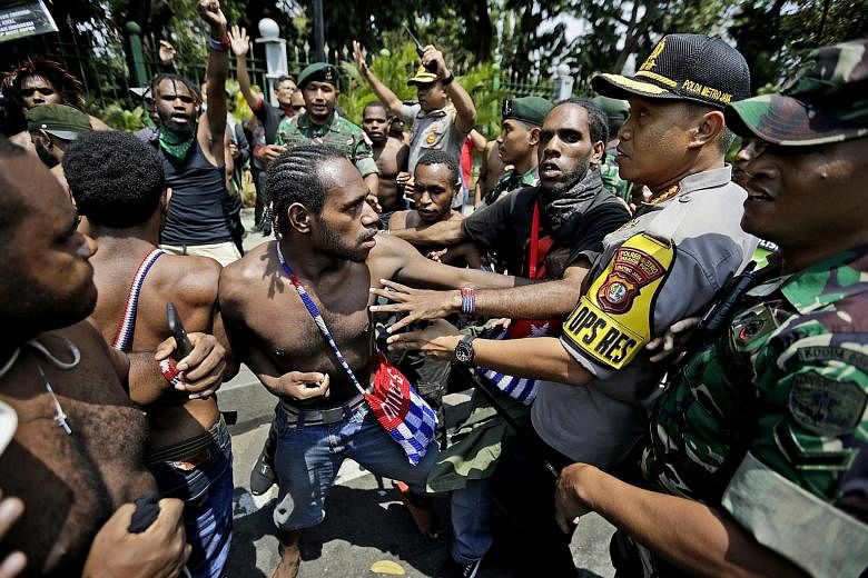 Papuan activists scuffling with police and soldiers during a rally near the presidential palace in Jakarta on Thursday. The latest spate of demonstrations was triggered by a racist slur against Papuan students.