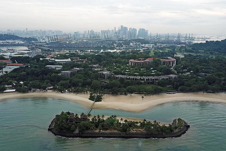 Palawan Beach in Sentosa is in the foreground. Behind it is the main Sentosa island, while Pulau Brani, where a "Downtown South" resort may be built in the future, can be seen in the background.