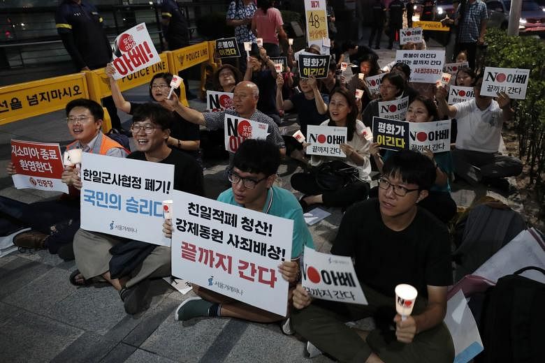 South Korean protesters at a rally targeted at the General Security of Military Information Agreement, in front of the Japanese Embassy in Seoul on Thursday. Local polls have indicated that more South Koreans are in favour of scrapping the deal, and 