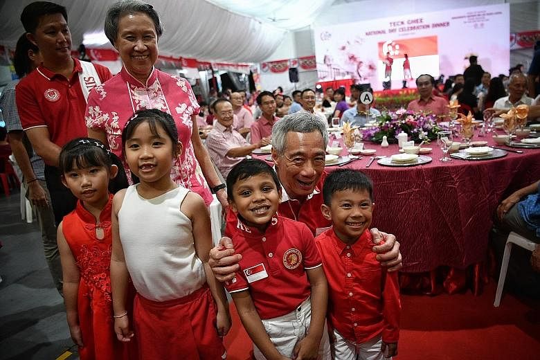 Prime Minister Lee Hsien Loong and Mrs Lee with young guests at the Teck Ghee National Day celebration dinner yesterday, which was attended by about 2,500 Teck Ghee residents and guests.