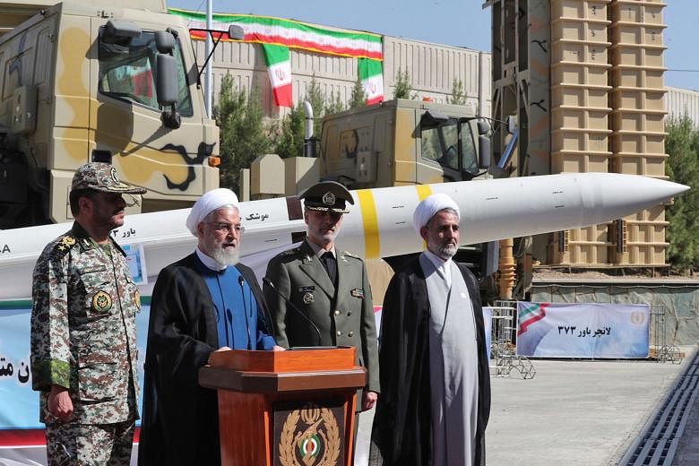 President Hassan Rouhani, seen here with Defence Minister Amir Hatami (third from left), announcing the debut of Iran's air-defence missile system, the Bavar-373, in Teheran last Thursday.