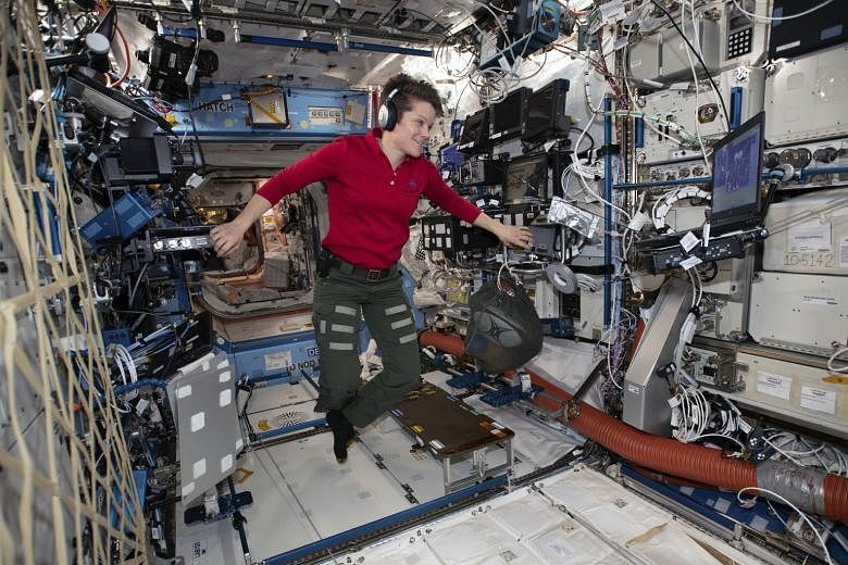 Astronaut Anne McClain looking at a laptop computer screen in the US Destiny laboratory module of the International Space Station. Nasa is checking a claim that she improperly accessed the bank account of her estranged spouse from the space station. 
