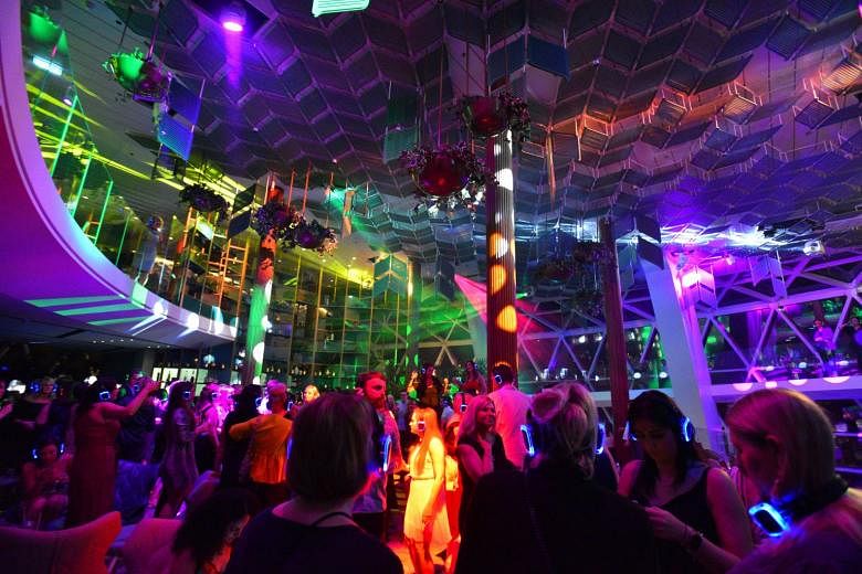 Clubbers in a silent disco at transformative space Eden on the Celebrity Edge, a new US$1 billion (S$1.38 billion) ship launched by Celebrity Cruises that aims to appeal to younger travellers.