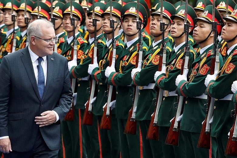 Australian Prime Minister Scott Morrison, seen here reviewing a guard of honour while in Vietnam last week, says Australia intends to prevent extremists from exploiting digital platforms to post extremely violent content. PHOTO: REUTERS