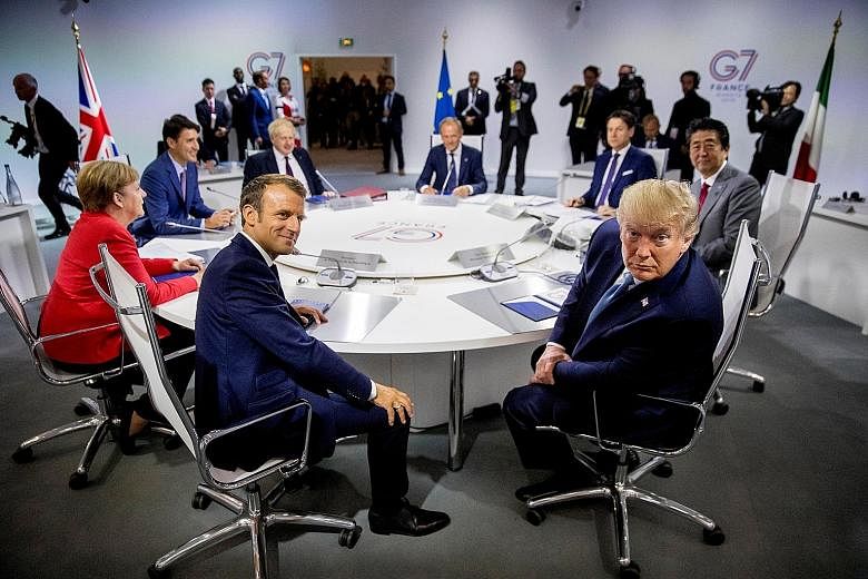 (Clockwise, from foreground left) French President Emmanuel Macron, German Chancellor Angela Merkel, Canadian Prime Minister Justin Trudeau, British Prime Minister Boris Johnson, European Council President Donald Tusk, outgoing Italian Prime Minister