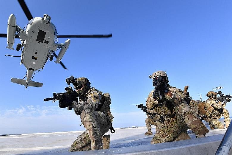 The South Korean Naval Special Warfare Group in a military drill yesterday on the islands called Dokdo in South Korea and Takeshima in Japan. Tokyo and Seoul have long been at loggerheads over the sovereignty of the group of islets, which lie about h