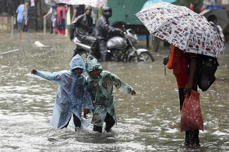 Children wading through a flooded street in Mumbai earlier this month. Home to nearly 22 million people, the financial capital of India is demanding more durable fixes to its flooding problem from policymakers.