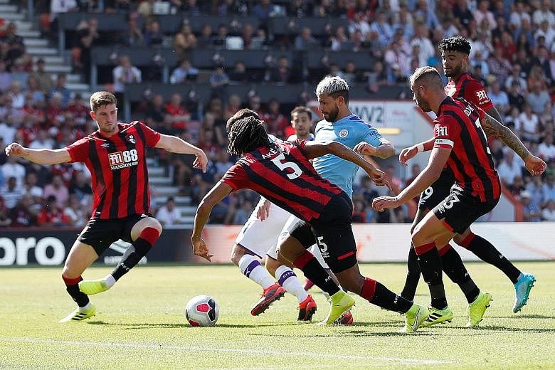 Sergio Aguero slaloming through a sea of defenders to convert Manchester City's third goal. It was the Argentinian striker's second of the game as he ended Bournemouth's resistance. PHOTO: REUTERS
