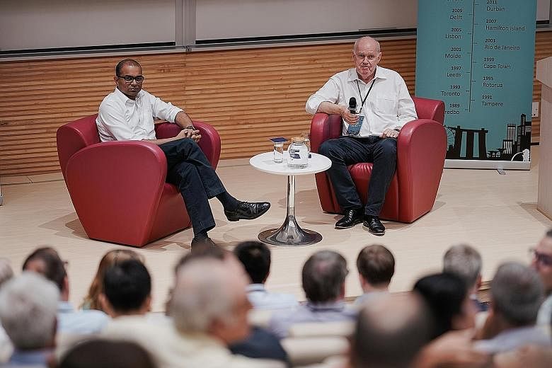 Senior Minister of State for Transport Janil Puthucheary with Professor David Hensher at the Thredbo Conference in NTU yesterday. Dr Janil said the authorities are taking "as light a touch of regulation as possible" to the all-in-one transit apps - t