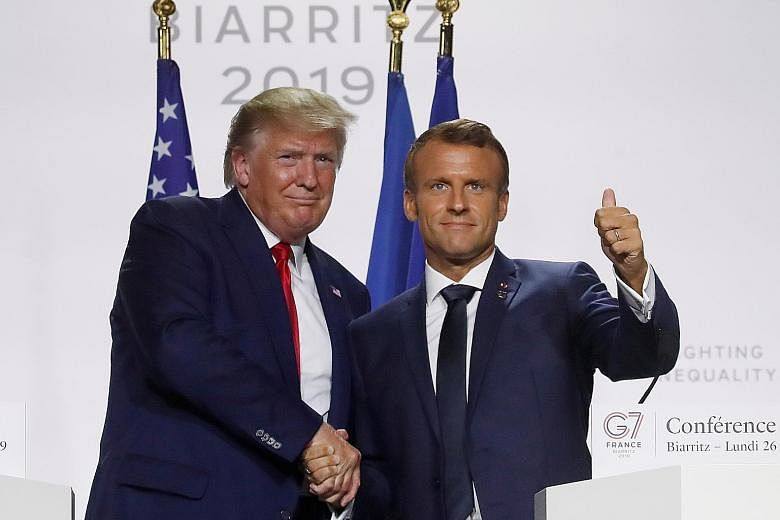 US President Donald Trump and French President Emmanuel Macron, after a joint press conference at the end of the G-7 summit in Biarritz, France, yesterday. The G-7 leaders have agreed to release more than US$20 million (S$27.8 million) of emergency a