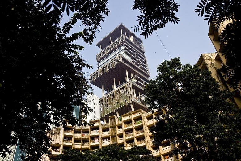 Mr Mukesh Ambani's 27-storey home, Antilia, photographed in 2011. The Mumbai property, which has three helipads, six floors of parking and a series of floating gardens, is one of the world's most expensive private residences.