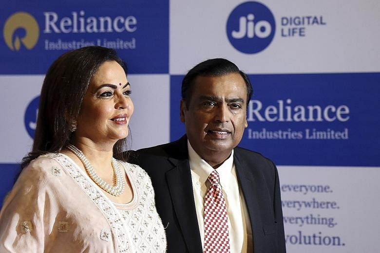Mr Mukesh Ambani, chairman of Reliance Industries, with his wife Neeta. Mr Ambani's late father started the family's business empire with US$100, and the clan now has a $69 billion fortune. PHOTO: ASSOCIATED PRESS
