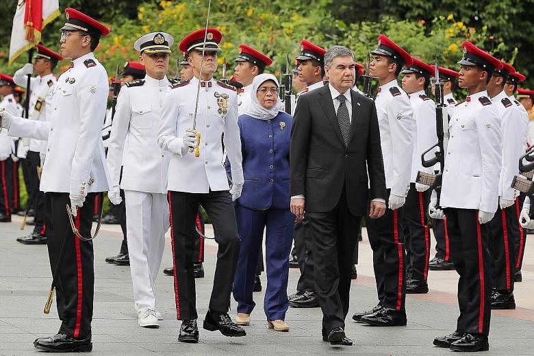 Turkmenistan President Gurbanguly Berdimuhammedow, accompanied by Singapore President Halimah Yacob, reviewing the guard of honour at the Istana yesterday. He left Singapore last night.