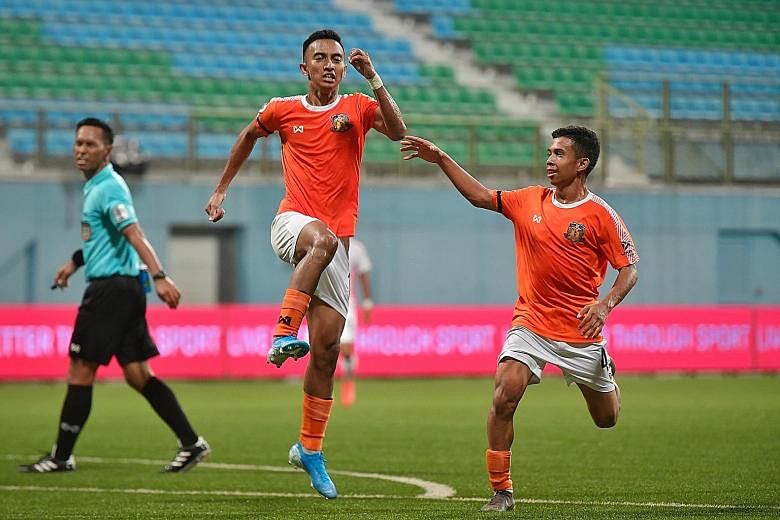 Hougang United striker Faris Ramli (middle) celebrating with Farhan Zulkifli after scoring the equaliser in the 1-1 draw with Albirex Niigata at the Jalan Besar Stadium last night. It was Faris' 13th goal of the season and the point lifted Hougang to top 