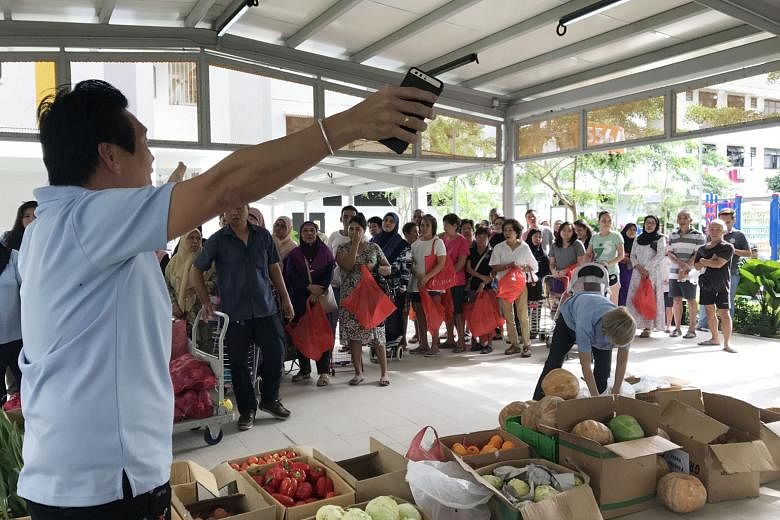 People waiting for the distribution of produce by The Food Bank Singapore. A Singapore Food Agency spokesman says Good Samaritan laws are being explored here. This could give businesses more protection when they donate food, and could raise the amoun