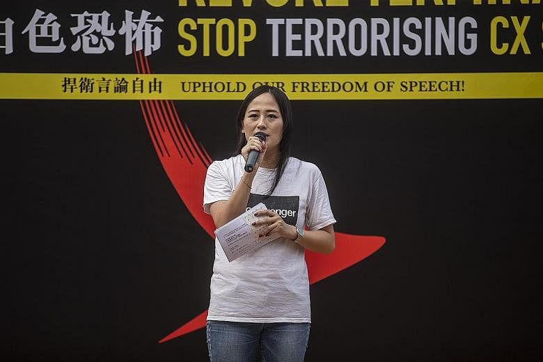 Former Cathay Pacific employee Rebecca Sy addressing the rally. Ms Sy, who was head of a flight attendants' association, said she was fired without explanation after managers saw her Facebook account. Protesters at a rally yesterday at Hong Kong's ce