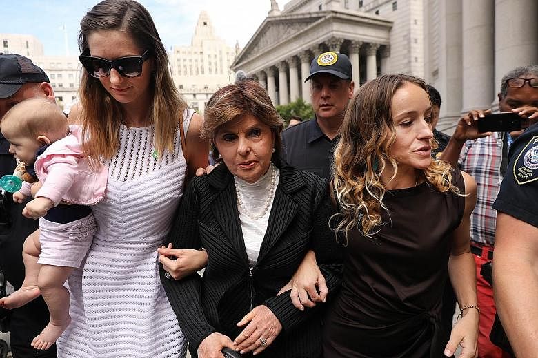 Attorney Gloria Allred (centre) leaving a New York courthouse on Tuesday with two women who have publicly accused Jeffrey Epstein of sexually assaulting them.