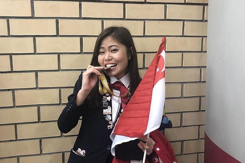 Ms Regina Chia with her gold medal at the closing ceremony of the 45th WorldSkills Competition on Tuesday night. ST PHOTO: JOLENE ANG Ms Regina Chia competing in her skill area of health and social care on the second day of the WorldSkills Competitio