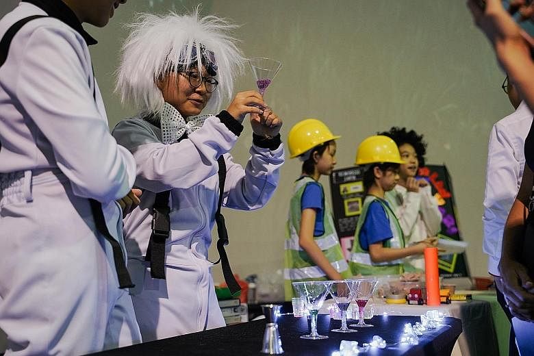 Participants demonstrating a science experiment during a media preview of the Singapore Science Festival on Tuesday. The festival will take place from tomorrow to Sept 15.