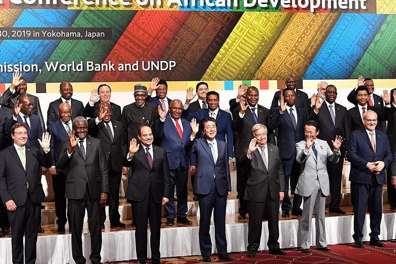 Japan's Prime Minister Shinzo Abe (centre), flanked by African Union chairman and Egyptian President Abdel Fattah al-Sisi and UN chief Antonio Guterres in a "family photo" with other participants at the Tokyo International Conference on African Devel