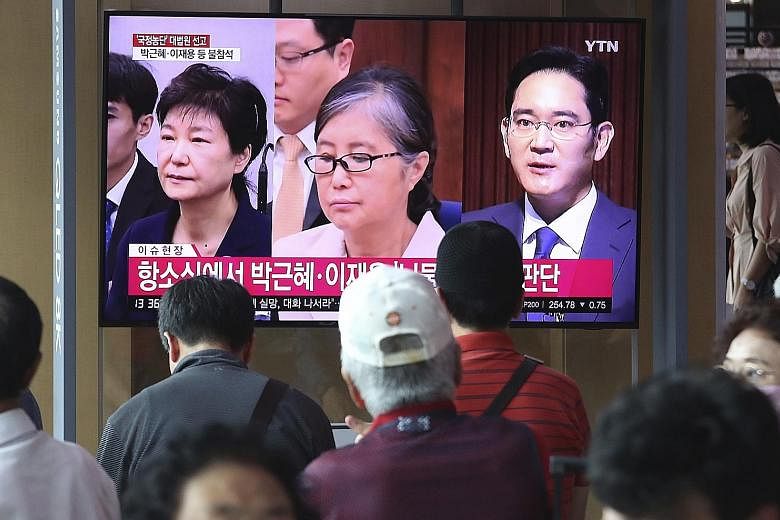 A news programme in Seoul yesterday showing (from left) South Korea's former president Park Geun-hye, her confidante Choi Soon-sil, and Samsung Group heir Lee Jae-yong as the country's top court sent Lee's case back for review by a lower court.
