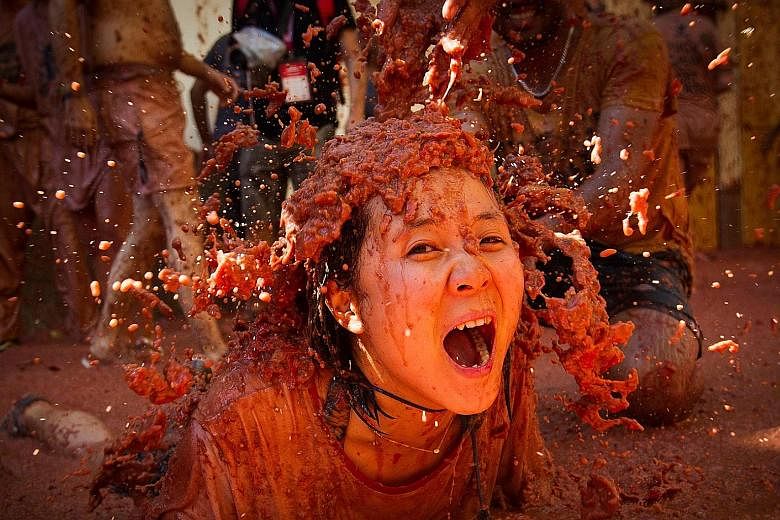 This reveller covered in tomato pulp was among the more than 20,000 people who pelted each other with ripe tomatoes on Wednesday in the annual "Tomatina" street battle in the eastern Spanish town of Bunol that has become a major tourist attraction. T