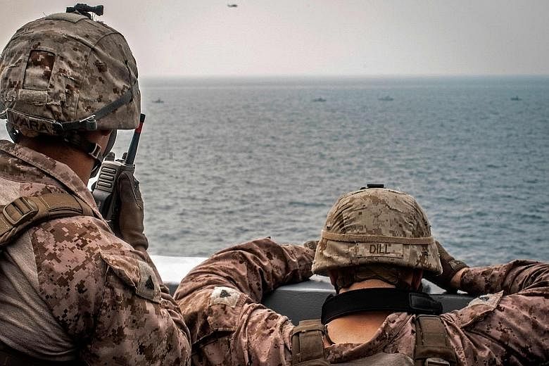 US sailors keeping watch on Iranian fast inland attack craft in the Strait of Hormuz earlier this month. Australia has joined the US operation in the strait, the third country to do so after Britain and Bahrain.