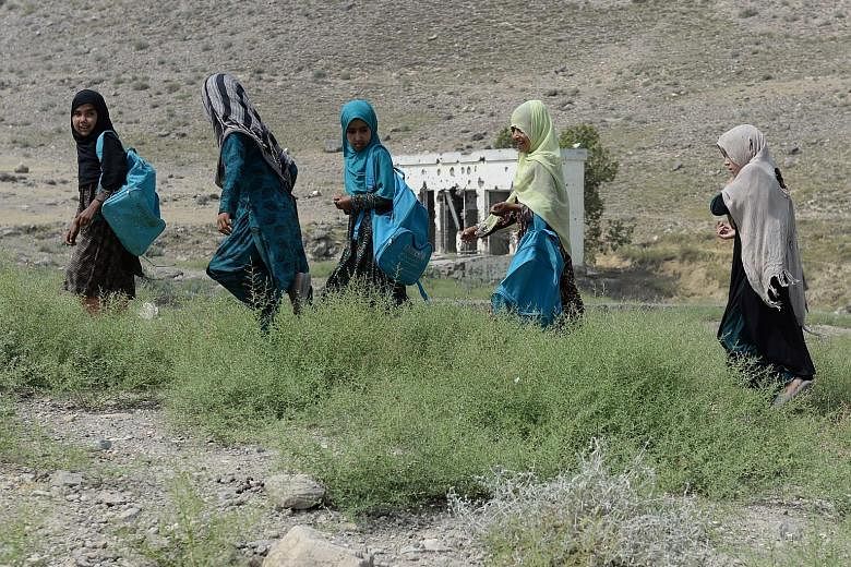 Schoolchildren leaving after class at a destroyed high school in Nangarhar province in eastern Afghanistan last month. The Taleban has not let up on its military operations, including attacks on civilians.