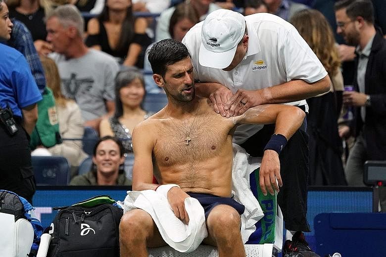 Novak Djokovic receiving treatment in between games against his second-round opponent Juan Ignacio Londero. PHOTO: AGENCE FRANCE-PRESSE