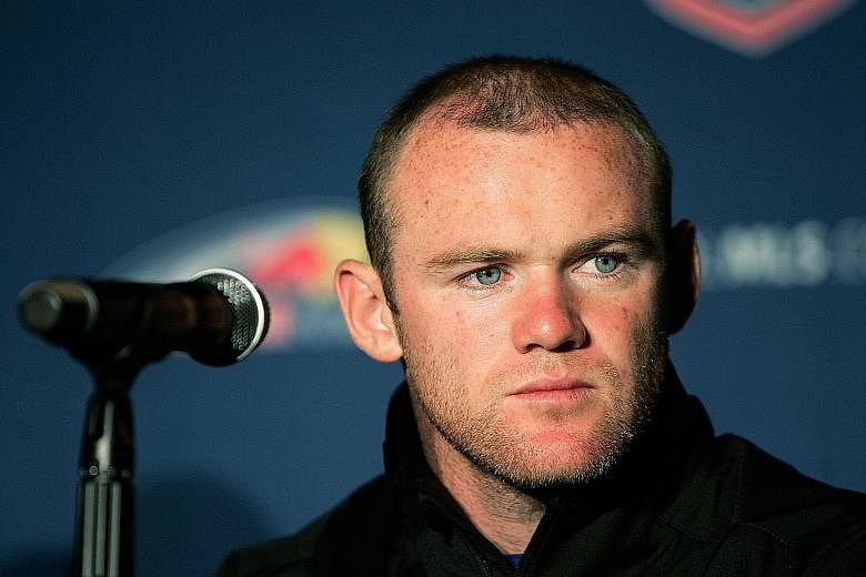 Wayne Rooney says The Sun's story and photos were a smear against him, making it "look like I took a girl back to my team hotel" in Vancouver.