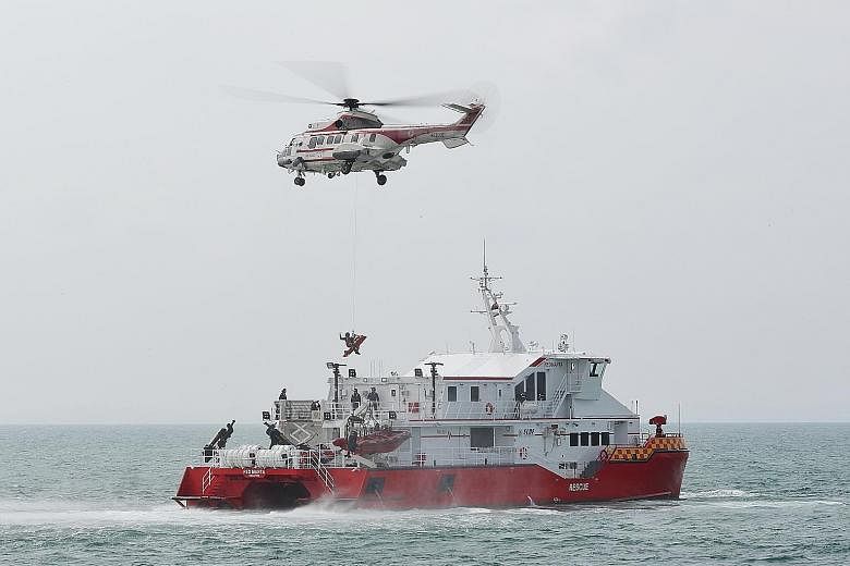 Passengers (above) disembarking from an SCDF Heavy Rescue Vessel at the HarbourFront Ferry Terminal during an exercise held yesterday that simulated the evacuation of 150 passengers on board a regional ferry involved in a collision in the waters sout